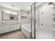 Bright bathroom with granite counters, soaking tub and walk-in shower with tile surround and glass door at 5818 Downfield Wood Dr, Charlotte, NC 28269