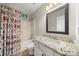 Bright bathroom featuring a marble vanity top, framed mirror, and shower-tub combo at 5818 Downfield Wood Dr, Charlotte, NC 28269
