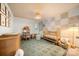 Bright Bedroom with crib, armchair, shelves, and patterned rug at 5818 Downfield Wood Dr, Charlotte, NC 28269