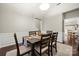 Inviting dining room with wainscoting detail, dark hardwood floors, and neutral wall color at 5818 Downfield Wood Dr, Charlotte, NC 28269