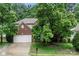 Charming brick two-story home featuring a two-car garage and mature trees at 5818 Downfield Wood Dr, Charlotte, NC 28269