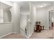 Hallway with stairs leading to the second level, adorned with chair and table at 5818 Downfield Wood Dr, Charlotte, NC 28269