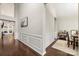 Hallway with dark wood floors, white trim, and view into dining area at 5818 Downfield Wood Dr, Charlotte, NC 28269