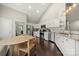 Bright kitchen with stainless appliances, white cabinets, granite countertops, and eat-in area at 5818 Downfield Wood Dr, Charlotte, NC 28269