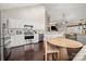 Kitchen featuring stainless appliances, white cabinets, granite countertops, and eat-in area at 5818 Downfield Wood Dr, Charlotte, NC 28269