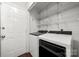 Convenient laundry room with shelving and updated washer and dryer at 5818 Downfield Wood Dr, Charlotte, NC 28269