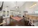Spacious living room with dark hardwood floors, vaulted ceiling, and kitchen view at 5818 Downfield Wood Dr, Charlotte, NC 28269