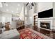 Bright living room featuring a fireplace, dark wood floors, and a large area rug at 5818 Downfield Wood Dr, Charlotte, NC 28269