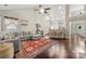 Open-concept living room with a high ceiling, hardwood floors, and stylish modern furnishings at 5818 Downfield Wood Dr, Charlotte, NC 28269