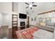 Open living room featuring hardwood floors, fireplace, built-in bookshelves, and a grey sofa at 5818 Downfield Wood Dr, Charlotte, NC 28269