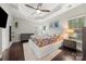 A spacious main bedroom with a tray ceiling, ceiling fan, and natural light at 5818 Downfield Wood Dr, Charlotte, NC 28269