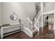 Entryway with staircase featuring dark wood floors, white trim, and decorative console table at 5818 Downfield Wood Dr, Charlotte, NC 28269