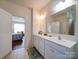 Well-lit bathroom featuring double vanity sinks and a view to the adjacent bedroom at 6266 Swanport Rd, Lancaster, SC 29720