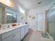 Bright bathroom with a double sink vanity and a glass enclosed shower at 6266 Swanport Rd, Lancaster, SC 29720