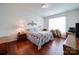 Bright bedroom with wood floors, a floral bedspread, and a functional desk area at 6266 Swanport Rd, Lancaster, SC 29720