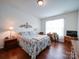 Light-filled bedroom with a desk, wood floors, and a decorative headboard at 6266 Swanport Rd, Lancaster, SC 29720
