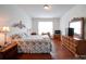 Bedroom featuring wood floors, a window, a decorative headboard, and natural lighting at 6266 Swanport Rd, Lancaster, SC 29720