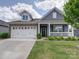 Charming home exterior features a well-manicured lawn, a welcoming front porch, and a two-car garage at 6266 Swanport Rd, Lancaster, SC 29720