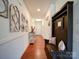 Inviting hallway featuring wood floors, decorative wall accents, and a functional bench with storage at 6266 Swanport Rd, Lancaster, SC 29720
