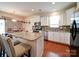 Stylish kitchen with a granite island, stainless steel appliances, and a seamless flow into the dining area at 6266 Swanport Rd, Lancaster, SC 29720