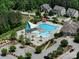 Aerial shot of neighborhood pool featuring sunshades, lounge chairs, splash pad, and playground at 6266 Swanport Rd, Lancaster, SC 29720
