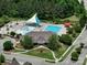 Aerial shot of neighborhood pool featuring a modern clubhouse, sunshades, and lounge chairs for residents at 6266 Swanport Rd, Lancaster, SC 29720