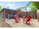 Backyard features a gravel patio, red Adirondack chairs, and partial shade at 6301 Cherrycrest Ln, Charlotte, NC 28217