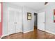 Bedroom with gleaming hardwood floors, and large closet with louvered doors at 6301 Cherrycrest Ln, Charlotte, NC 28217
