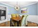 Cozy dining room with hardwood floors and stylish light fixture at 6301 Cherrycrest Ln, Charlotte, NC 28217
