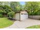 Detached garage with a multi-paneled door and neatly trimmed bushes at 6301 Cherrycrest Ln, Charlotte, NC 28217