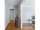 Stylish hallway with wood floors, blue walls, wood console table, and a decorative mirror at 6301 Cherrycrest Ln, Charlotte, NC 28217