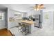 Bright kitchen with white cabinets, stainless steel appliances, and butcher block island with seating at 6301 Cherrycrest Ln, Charlotte, NC 28217
