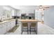 Bright kitchen with white cabinets and a butcher block island with seating at 6301 Cherrycrest Ln, Charlotte, NC 28217