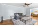 Inviting living room with wood floors, plush rug, blue walls, and a cozy sofa at 6301 Cherrycrest Ln, Charlotte, NC 28217