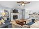 Inviting living room featuring a brick fireplace and open layout to kitchen at 6301 Cherrycrest Ln, Charlotte, NC 28217