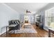 Inviting living room with wood floors, plush rug, blue walls, and a cozy sofa at 6301 Cherrycrest Ln, Charlotte, NC 28217