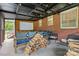 Inviting outdoor living space featuring a cozy seating area, fireplace, and screen for entertainment at 6301 Cherrycrest Ln, Charlotte, NC 28217