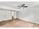 A partially finished basement bedroom with durable floors, closet space, and a ceiling fan at 6839 Wagon Oak Rd, Charlotte, NC 28212