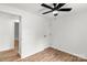 A simply designed bedroom featuring new floors, a ceiling fan, and fresh white paint at 6839 Wagon Oak Rd, Charlotte, NC 28212
