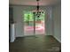 Dining area with decorative lighting and access to an outdoor deck at 6839 Wagon Oak Rd, Charlotte, NC 28212