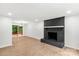 Bright living room features a brick fireplace, recessed lighting, and sliding glass doors to the outside at 6839 Wagon Oak Rd, Charlotte, NC 28212