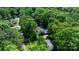 Overhead shot of home nestled among mature trees, featuring a pool and outdoor space at 701 5Th Ne Ave, Conover, NC 28613