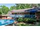 Backyard view featuring an above-ground pool, wooden deck, and a brick home exterior at 701 5Th Ne Ave, Conover, NC 28613