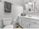 Functional bathroom with a white vanity, ample storage, a toilet, and a towel rack for convenience at 701 5Th Ne Ave, Conover, NC 28613