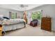 Bright bedroom features a ceiling fan, four-poster bed, plush carpet, and dual windows for natural light at 701 5Th Ne Ave, Conover, NC 28613
