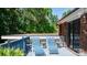 Relaxing deck with blue lounge chairs and lush green surroundings at 701 5Th Ne Ave, Conover, NC 28613