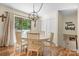 Bright dining room featuring a round table, light wood chairs, hardwood floors, and large window view at 701 5Th Ne Ave, Conover, NC 28613