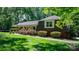 Charming home featuring mature landscaping, brick accents, and a welcoming facade with a cozy front porch at 701 5Th Ne Ave, Conover, NC 28613