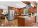Spacious kitchen with stainless steel refrigerator and wood cabinets at 701 5Th Ne Ave, Conover, NC 28613