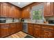Updated kitchen with stainless steel dishwasher, wood cabinets, and tile backsplash at 701 5Th Ne Ave, Conover, NC 28613